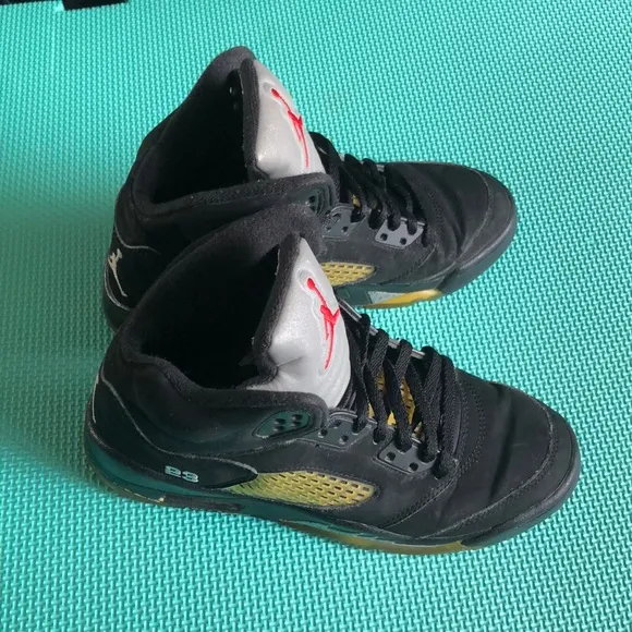 Air Jordan Kids Black and Gold Sneakers with Red Logo