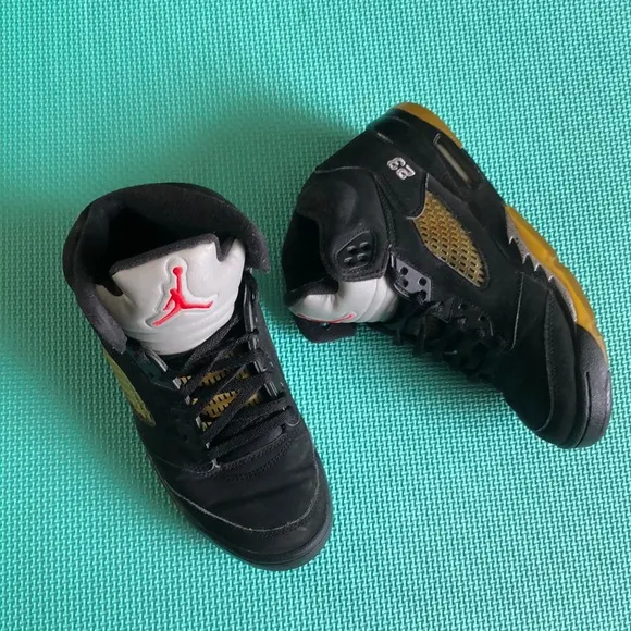 Air Jordan Kids Black and Gold Sneakers with Red Logo