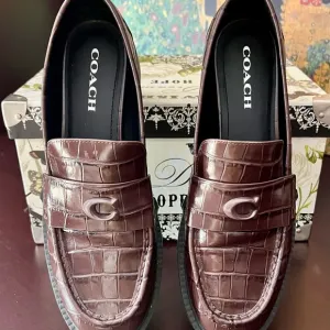 COACH Women’s Chocolate Brown Crocodile Embossed Leather Slip-On Loafers