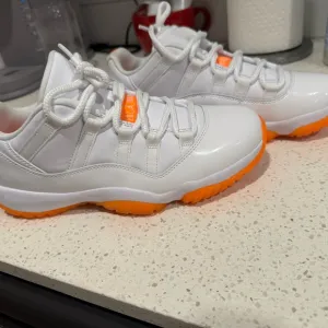 Jordan White and Orange Sneakers with Classic Silhouette