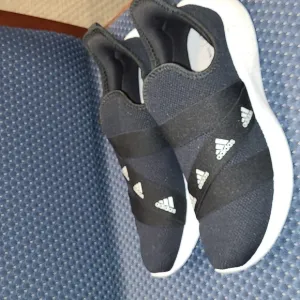 NWOT-Adidas Slip-on Sneakers.  BLACK AND WHITE.  Woman's size 12/men's size 10.5